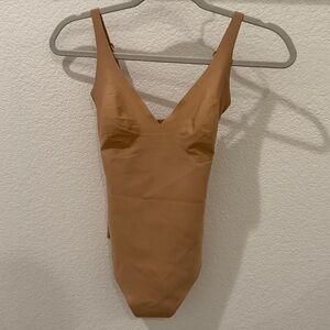SKIMS unlined plunge thong bodysuit in Clay